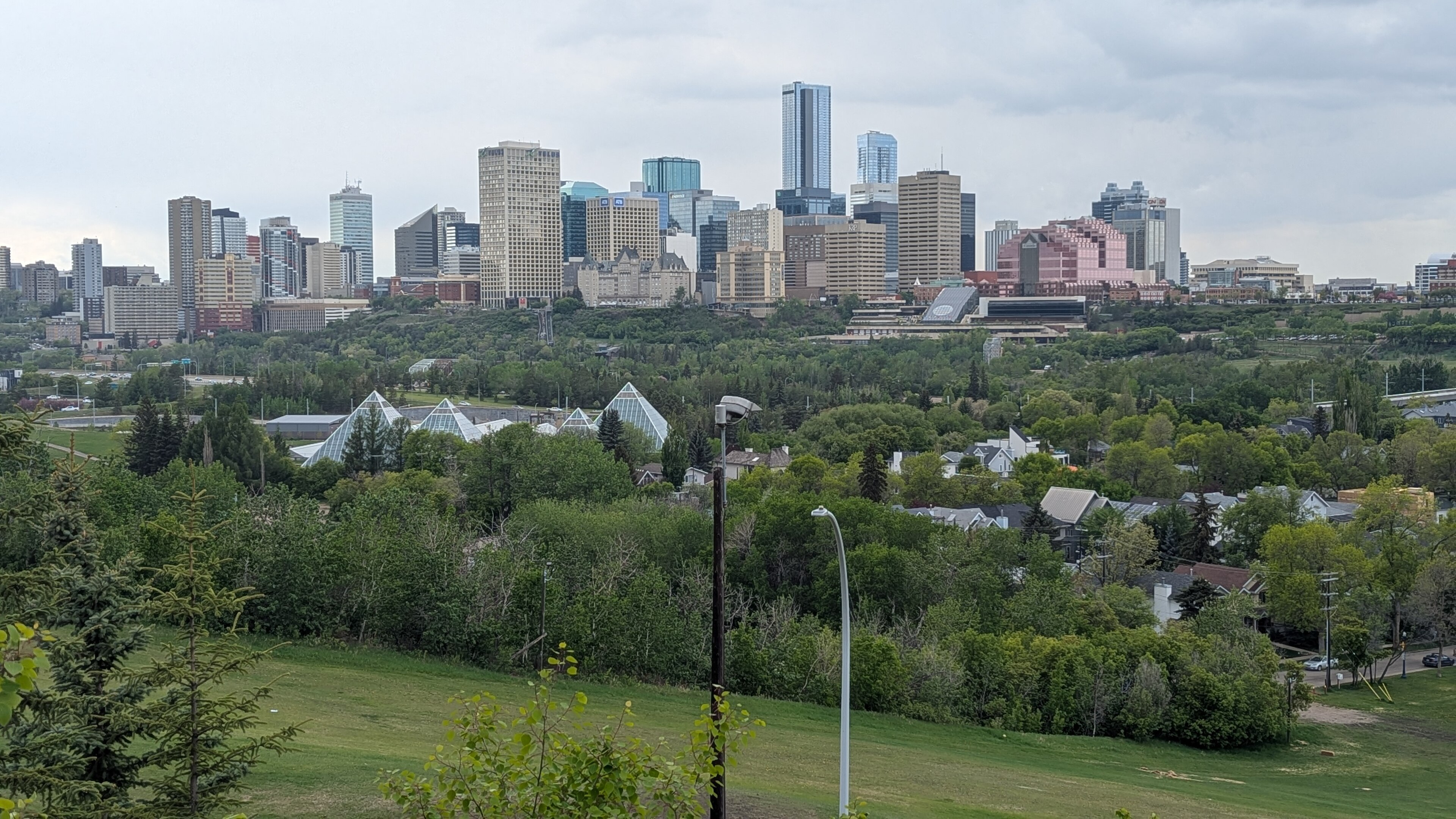Downtown Edmonton skyline seen past the Muttart Conservatory's glass pyramids